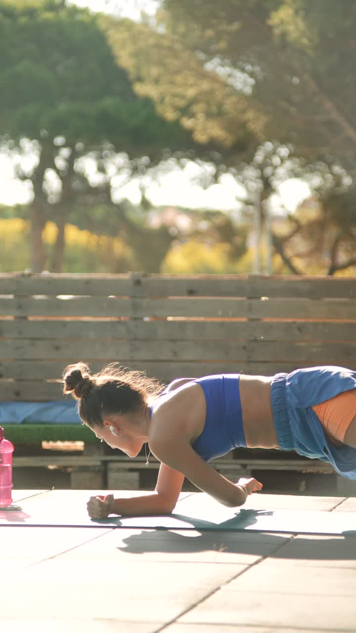 Woman doing side plank exercise outdoors