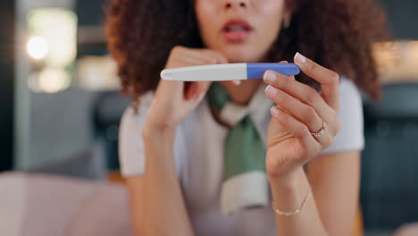 a woman looks concerned at a pregnancy test