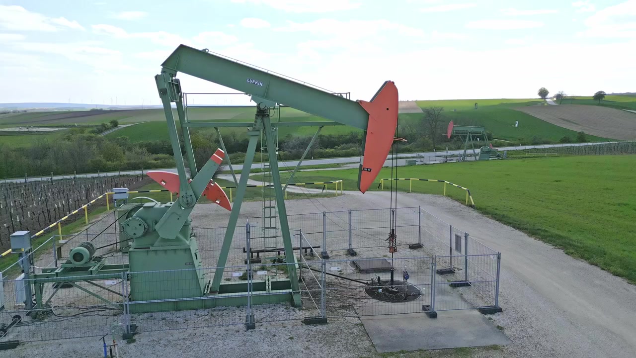 Motion Of Derrick Pumping Oil From The Ground In The Petroleum Of Zistersdorf, Austria. - aerial orbit