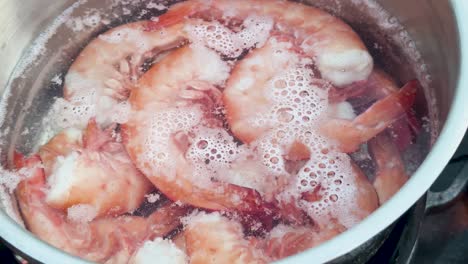 shrimp cooking in boiling water with bubbles