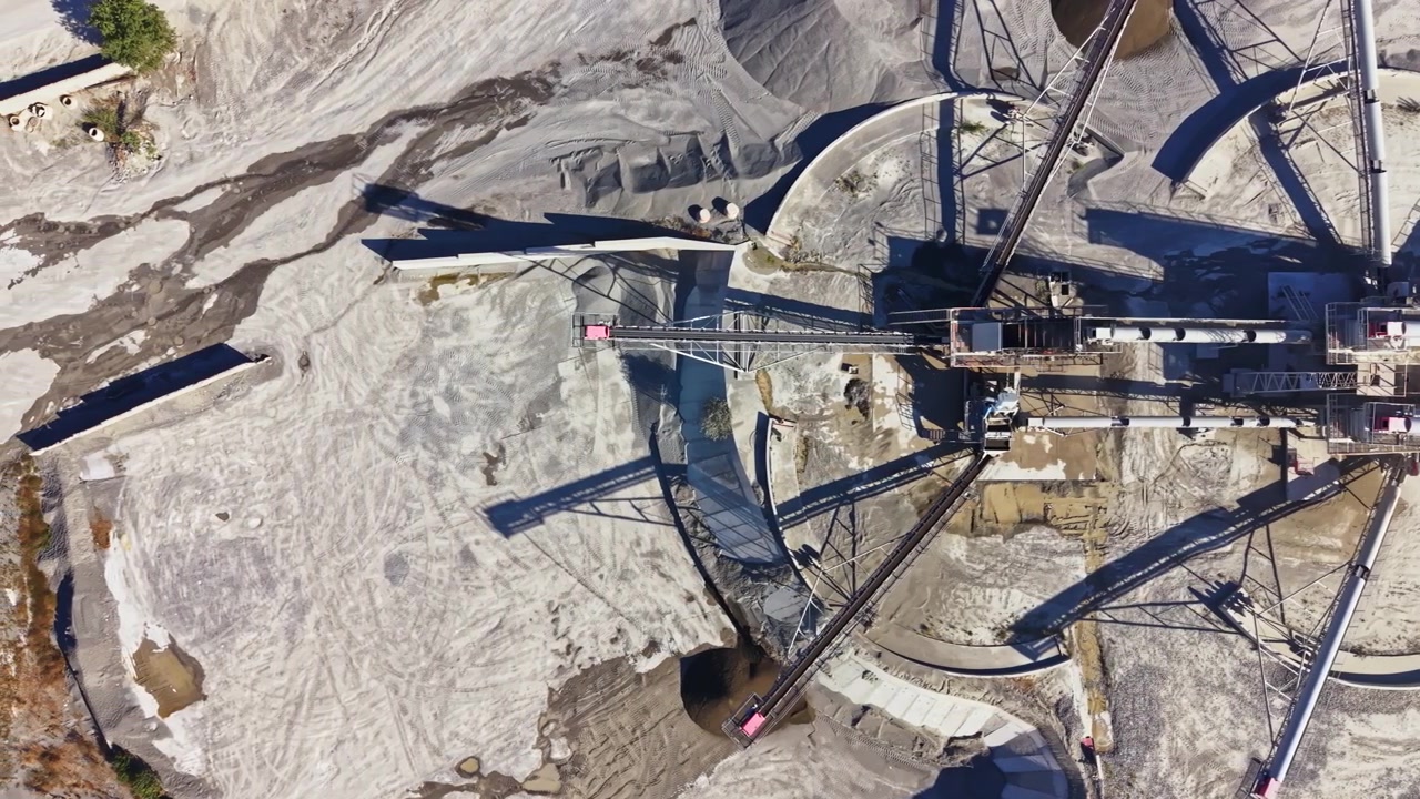 Granite quarry in operation with machinery and equipment moving granite materials on the site
