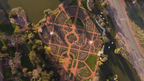 Aerial-top-down-of-beautiful-symmetric-rose-art-park-in-Palermo-District-of-Buenos-Aires-during-sunset---Circle-shot