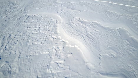 aerial flying over endless field of snow on glacier