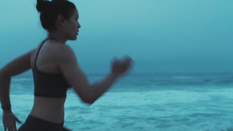 woman running on the beach at sunset