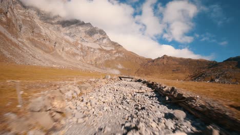 low-altitude-fast-flight-in-a-rocky-riverbed-under-a-bridge-with-a-FPV-Drone