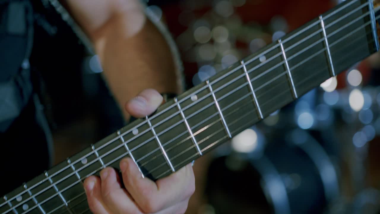 Close-up of a Guitarist Playing a Multi-String Guitar on Stage