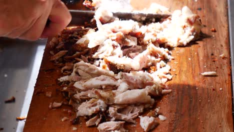 un primer plano de una persona cortando un kebab doner con un cuchillo
