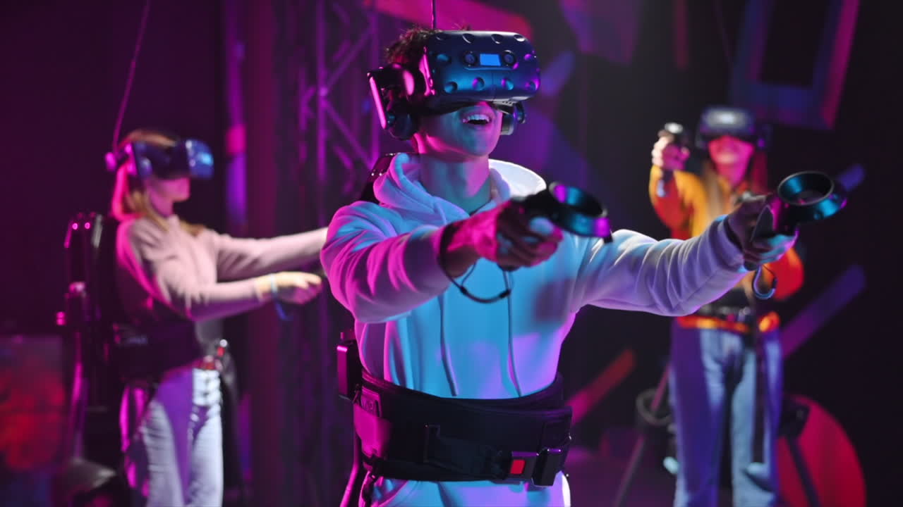 Group of joyful, interested young people playing on VR treadmill with helmets and controllers. Slow motion