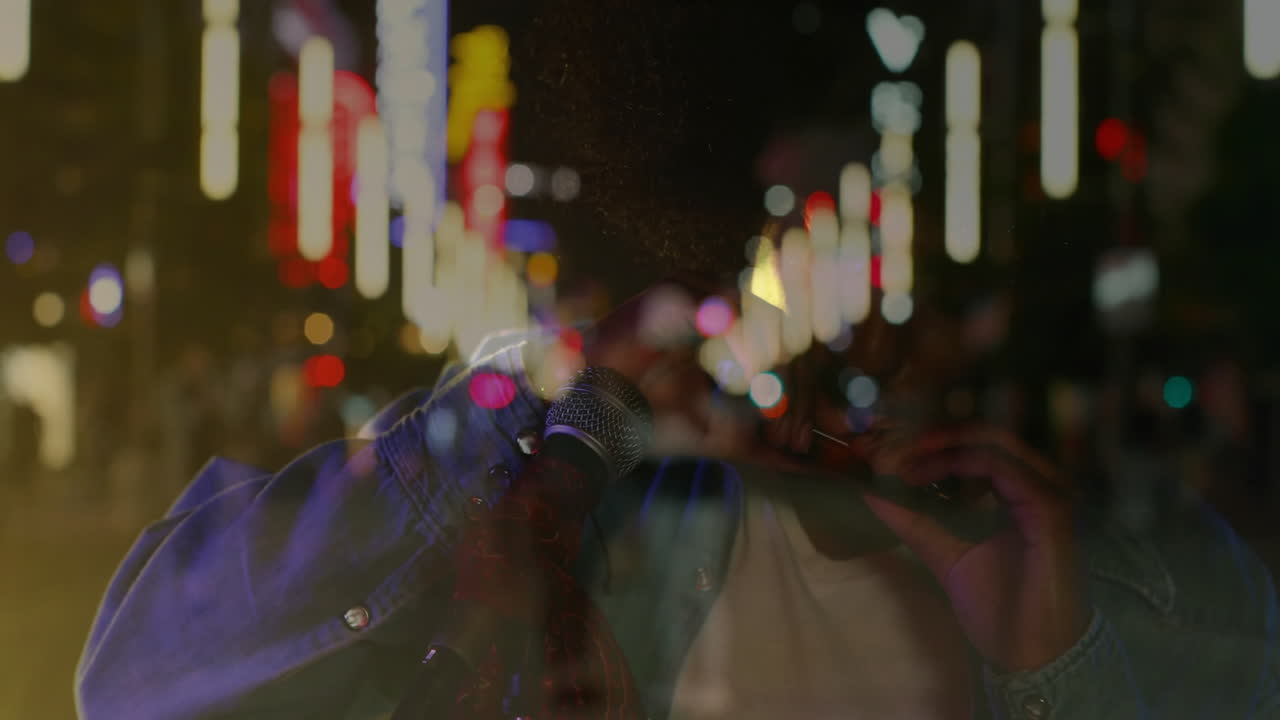 male musician playing harmonica on city street at night, with animated neon music chart overlays