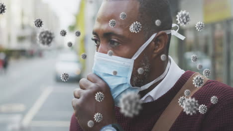 covid-19 cells floating against african american senior man wearing face mask couching