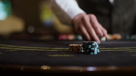 croupier collecting poker chips.