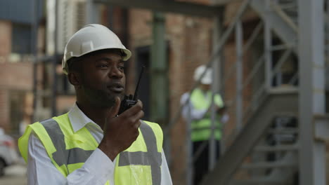 construction worker communicating on walkie-talkie