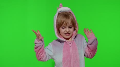 Child-girl-in-unicorn-pajamas-making-silly-funny-faces,-fooling-around,-dancing-on-chroma-key