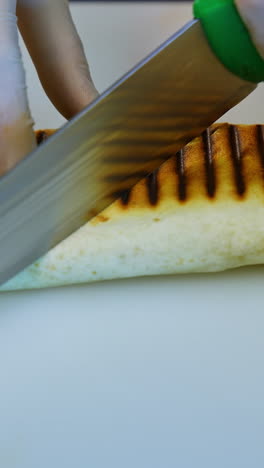cutting a grilled tortilla wrap