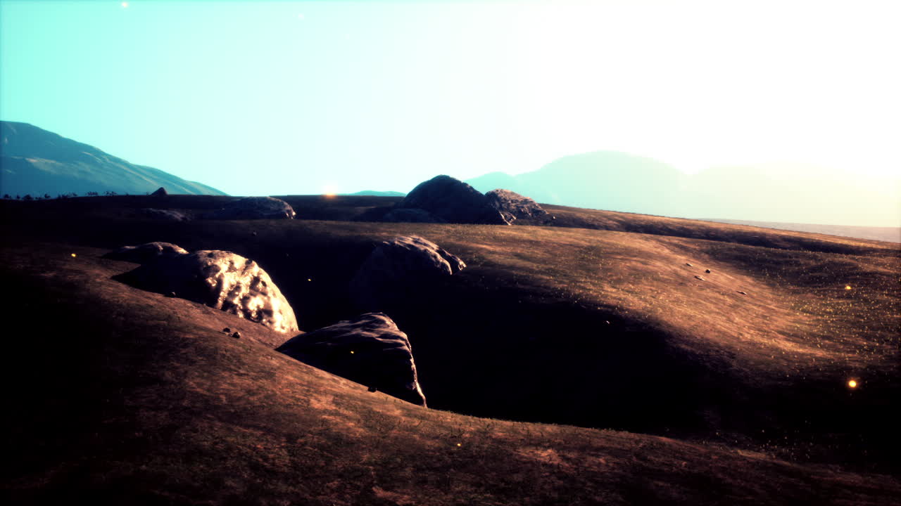 una hermosa vista de colinas y montañas con un cielo azul claro.