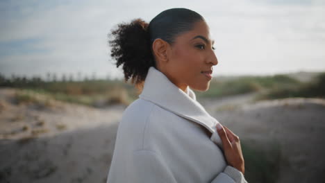 Peaceful-african-american-walking-in-sunlight-closeup.-Happy-calm-woman-enjoying