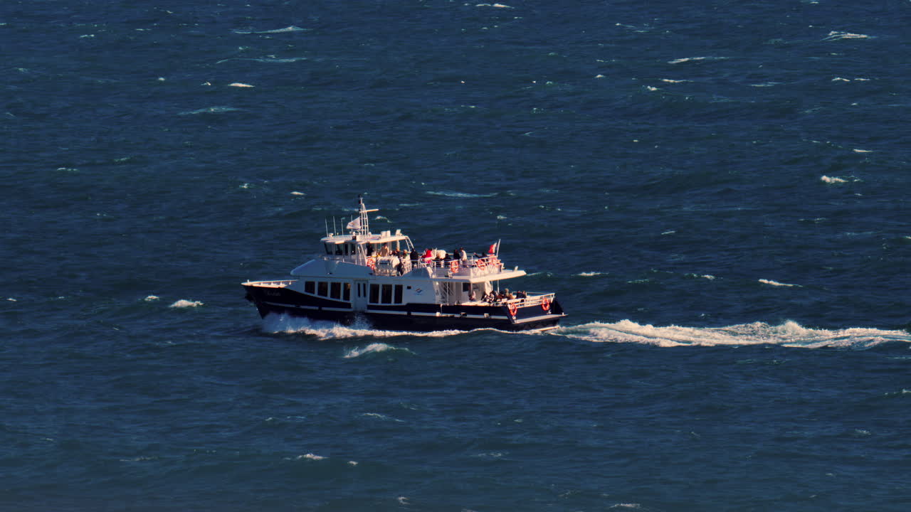Nice, France - March 17, 2025: View of a boat moving on the blue sea in daylight