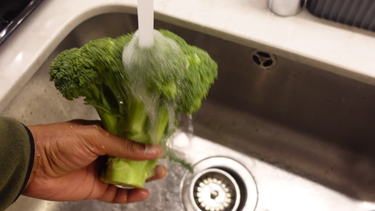 Washing Broccoli in Kitchen Sink