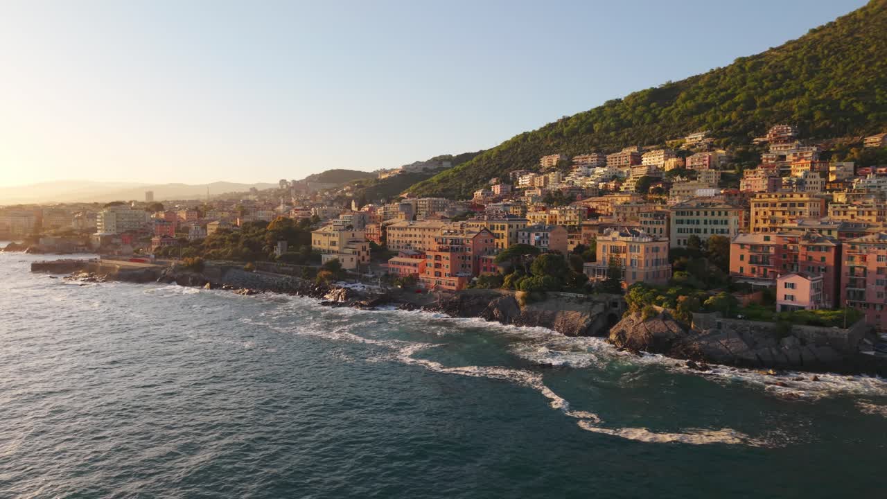 Sunset over coastal town with colorful buildings and the Mediterranean Sea
