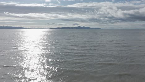 Low-aerial-tilt-up-along-the-Great-Salt-Lake,-Utah-on-a-sunny-spring-day