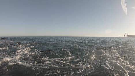 Waves-on-the-shoreline-during-a-sunny-day,-Spain