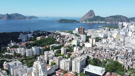 sugar loaf landscape at rio de janeiro aerial shots showing buildings, sea, favela on a sunny day