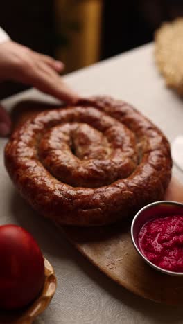 spiral sausage dish served with horseradish dip on easter table