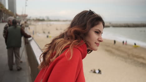 Young-girl-looking-at-something-on-the-seafront