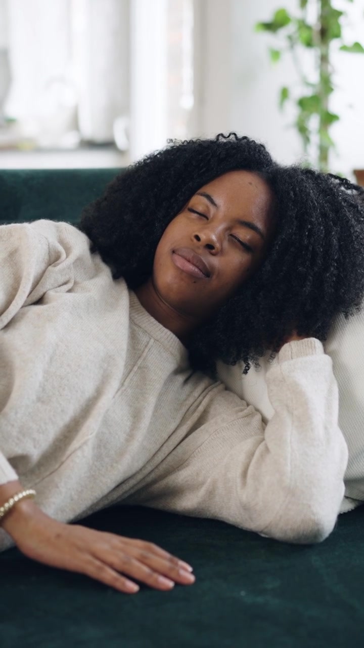 Young African American Woman Sleeping Peacefully on a Couch