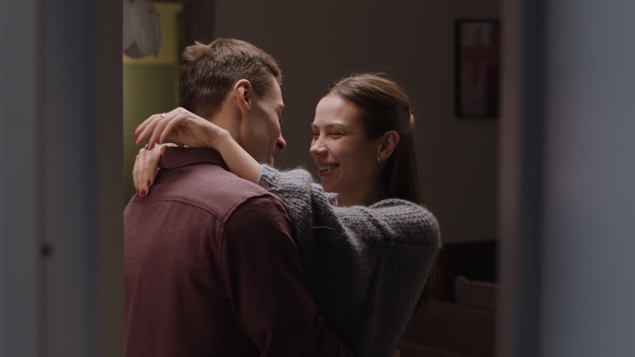 Couple Hugging and Kissing at Home