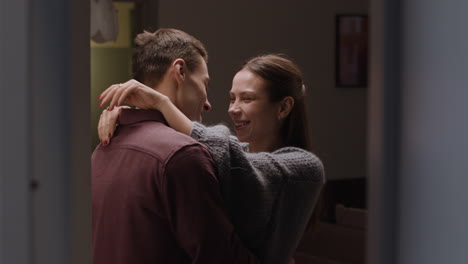 couple hugging and kissing at home