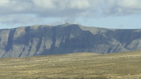 Time-Lapse-Zoom-Out-of-Radar-Station-on-Cliff-Top,-Lanzarote,-Canary-Islands,-Spain