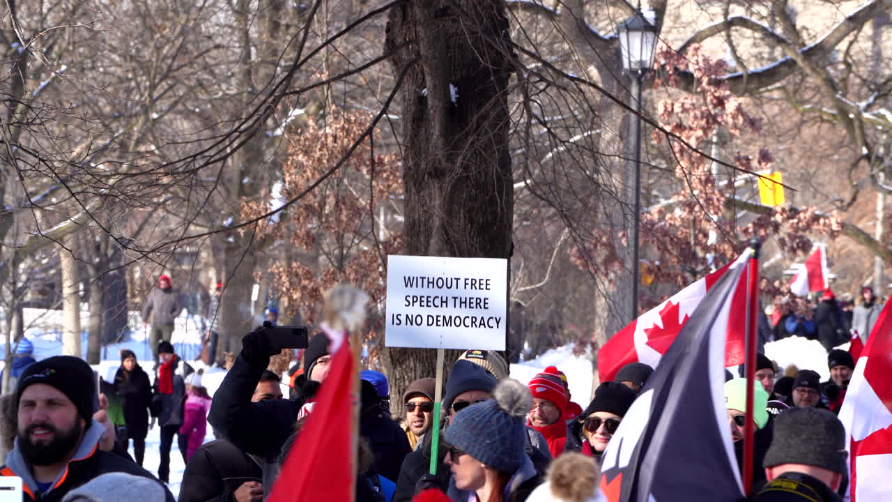Man with freedom of speech sign protesting anti covid mandates in Toronto