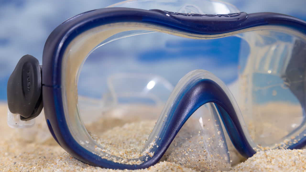 A snorkel mask on the beach