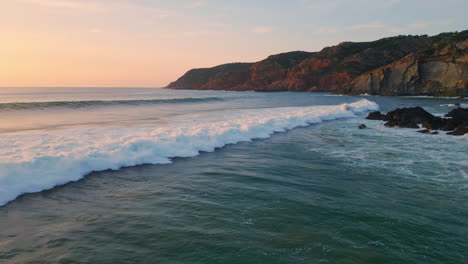 panoramic sea waves splashing sunrise coastline. rocky dawn cliffs foaming water