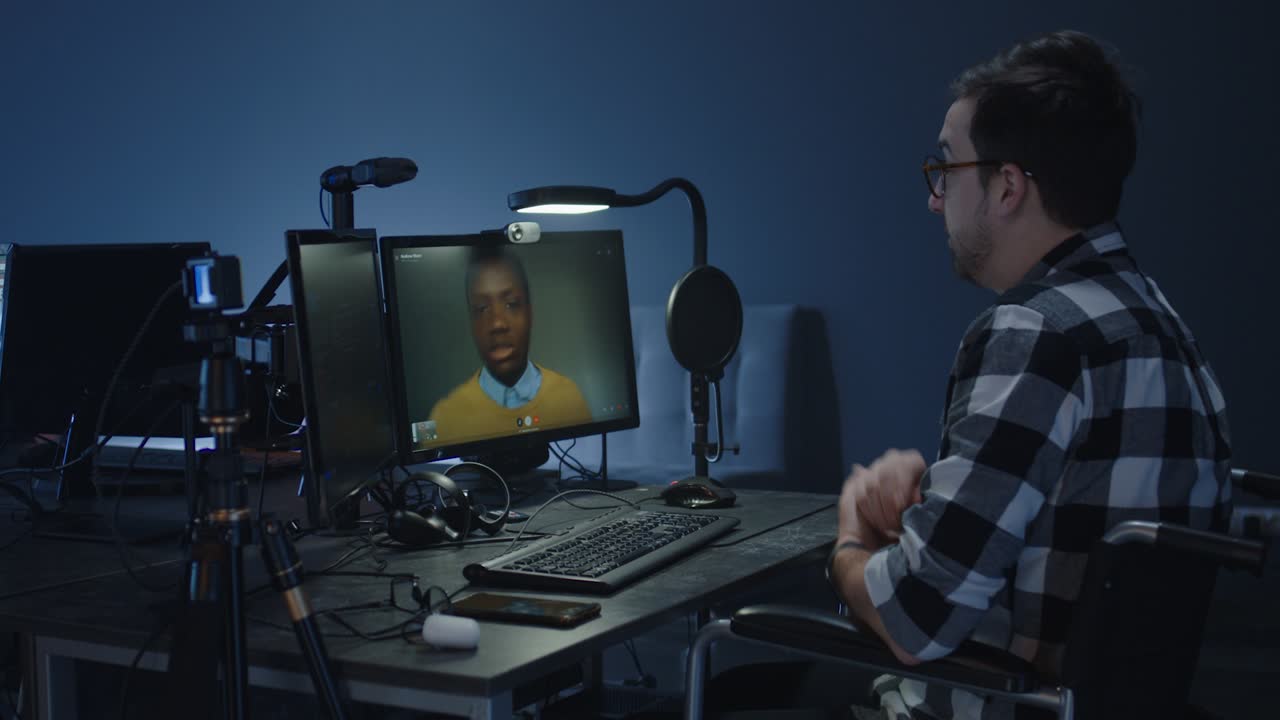 Man in Wheelchair Participating in a Video Conference