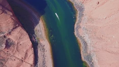 aerial shot of boats on the river in a canyon