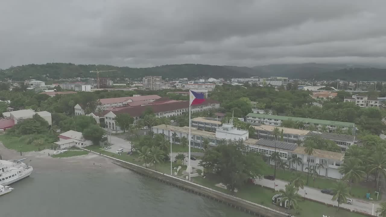 The Philippine flag at Subic Bay proudly flutters, showcasing its vibrant colors: a blue field representing peace.