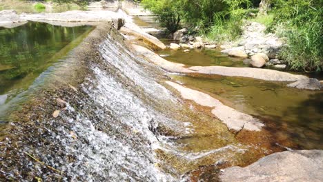 side view of water flowing down an overflow drainage system in wang ta krai nature park in nakhon nayok, thailand