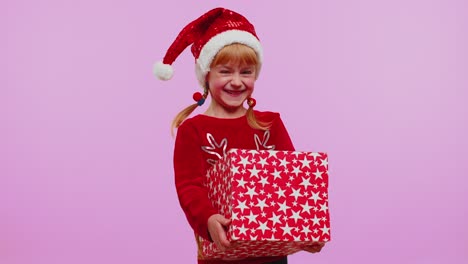 Girl-in-Christmas-red-sweater-hat-smiling,-unwrapping-gift,-opening-box-with-pet-cat,-great-surprise