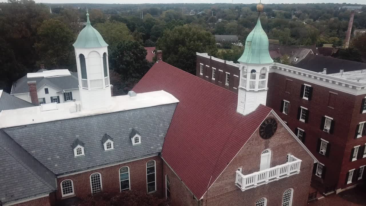 Aerial View of a Historic Brick Building with Two Towers