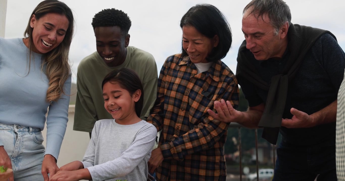 Família multigeracional feliz cozinhando juntos com uma criança.