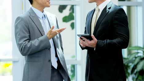 multi ethnic male female business team using tablet