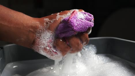 washing a cloth in soapy water