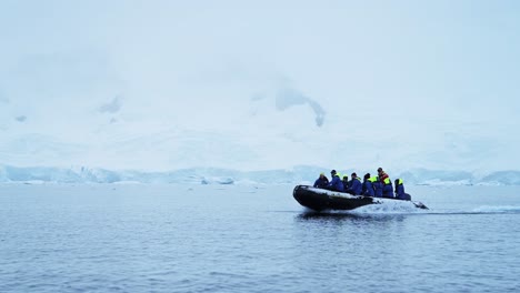 antarctica expedition: group of tourists in a zodiac boat