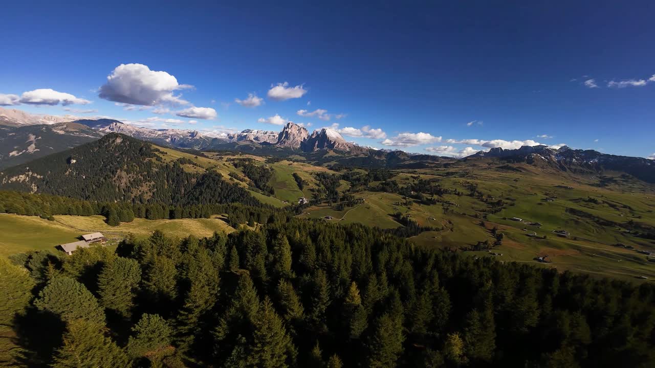 Alm pastures, high altitude mountain meadows used for grazing livestock during the summer months. Part of traditional Alpine agriculture. Beautifull dolomites, Italy. Aerial FPV drone video