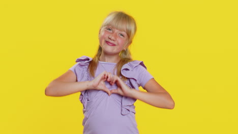 School-child-girl-makes-heart-gesture-demonstrates-love-sign-expresses-good-feelings-and-sympathy