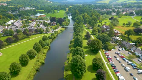 aerial drone shot overflying the river tweed at peebles in the scottish borders heading southeast towards priorsford bridge