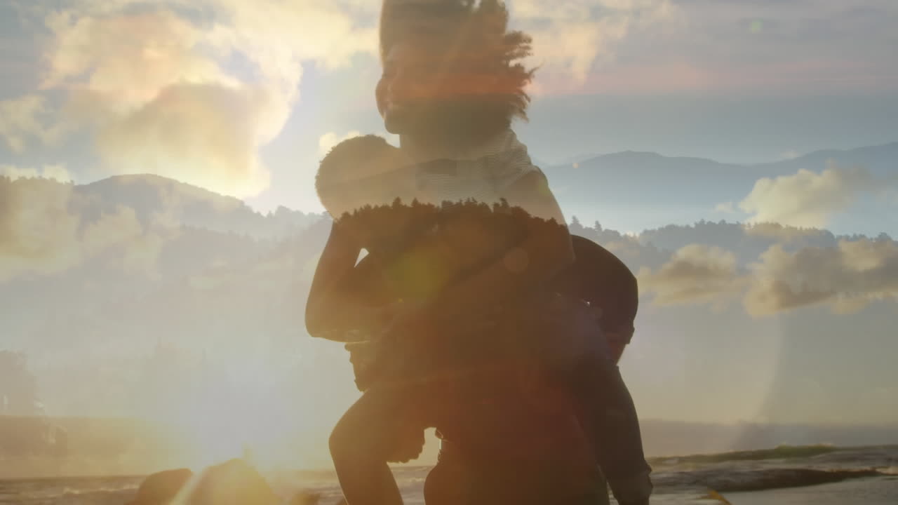 Animation of happy african american couple having fun at beach over landscape