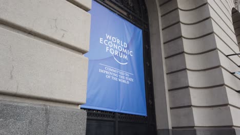 world economic forum banner on building exterior